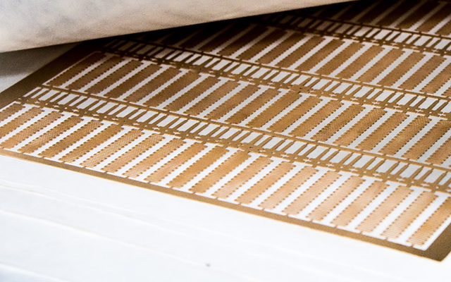 A sheet of super thin beryllium copper photo etched by United Western Enterprises, Inc.