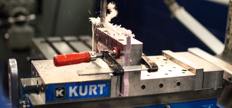 CNC machine drilling the hole at the steel shaft